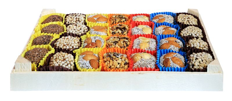 Turkish sweets, candies in a wooden box on the white background, isolated
