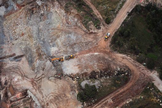 A top view earth moving activities at a quarry.