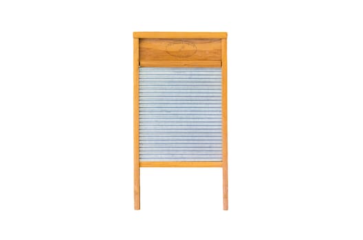 Antique wooden washboard standing upright in front of a white background
