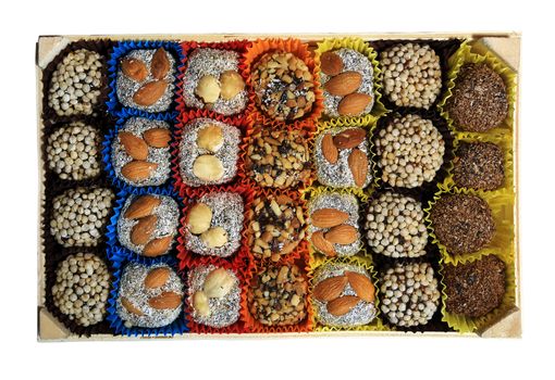 Turkish sweets, candies in a wooden box on the white background, isolated
