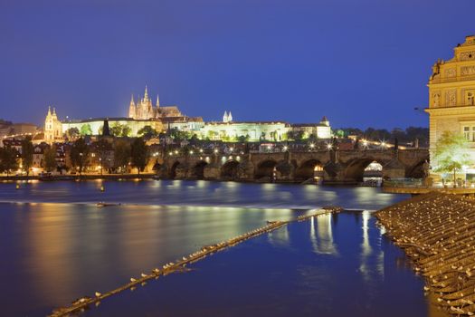 czech republic, prague - charles bridge and hradcany castle at dusk