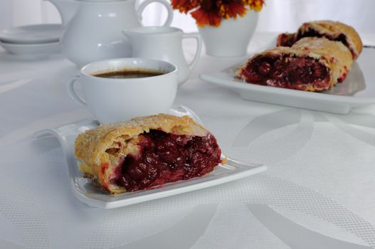 Piece of cherry strudel on the coffee table