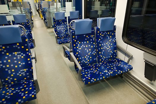 Interior of a passenger train with empty seats