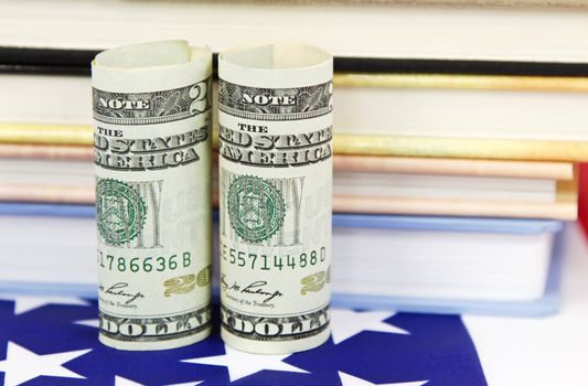 American dollars placed near colorful education symbols and on flag reflect strategic financial policy to invest in jobs and career training.
