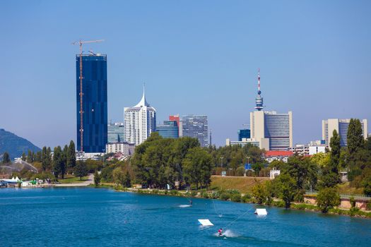 Waterskiing in Vienna with modern city skyline on background, Austria
