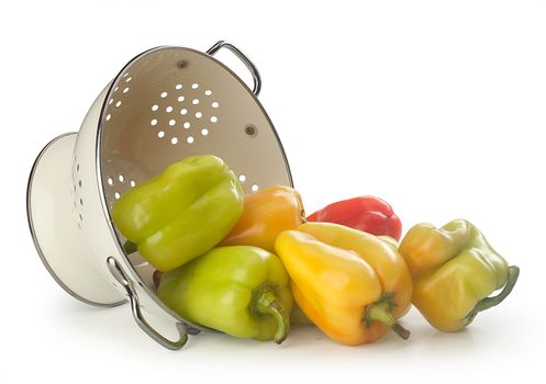 Fresh sweet peppers in the white enamelled colander