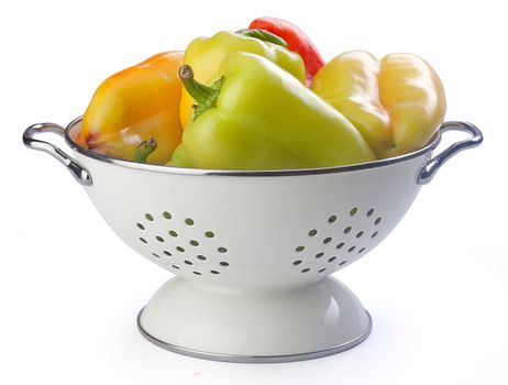 Fresh sweet peppers in the white enamelled colander