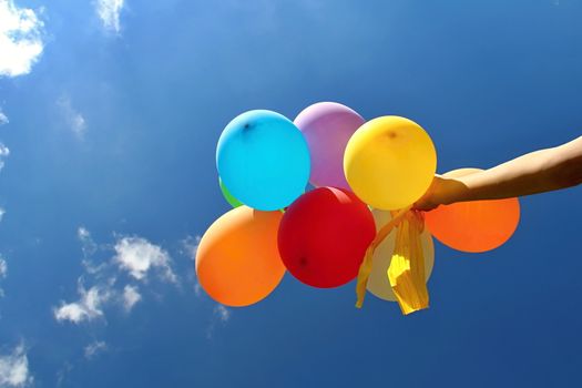 Photo shows colourful balloons in the sky.