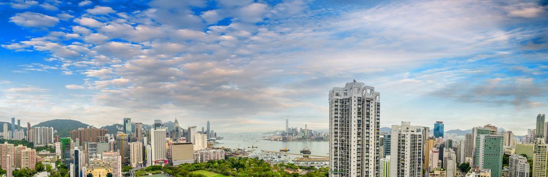 HONG KONG - MAY 12, 2014: Stunning panoramic view of Hong Kong Island and Kowloon on a cloudy day. Last year HK hosted more than 54 million visitors, most of them from the mainland.