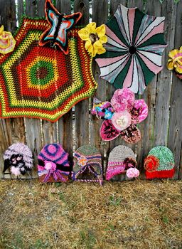 Colorful crochet patterns displayed outside.