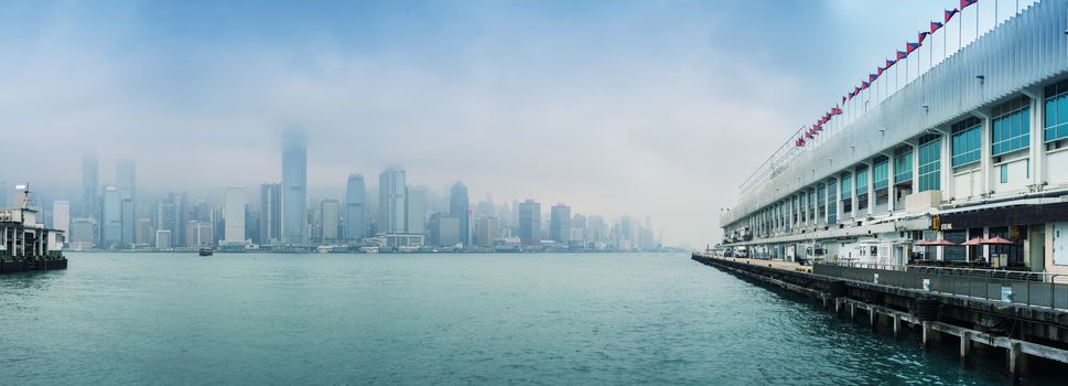 HONG KONG - MAY 12, 2014: Stunning panoramic view of Hong Kong Island from Kowloon port on a cloudy day. Last year HK hosted more than 54 million visitors, most of them from the mainland.