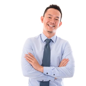 Handsome Asian business man smiling, standing isolated over white background.