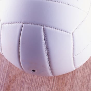 White volley ball over wooden surface, close up