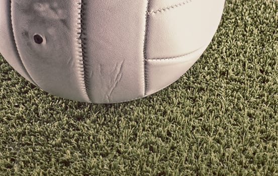 White volley ball over a green grass field, Hdr image
