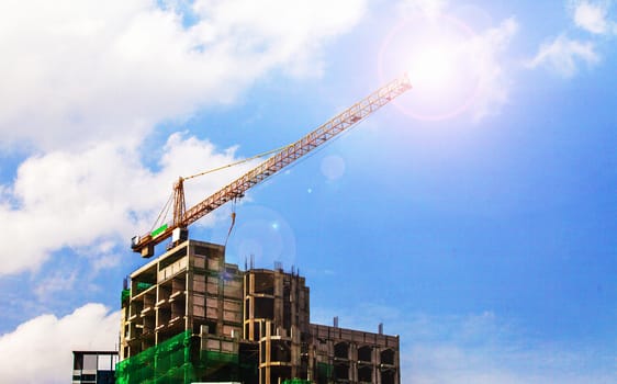 flare lighting Construction site with cranes on sky background