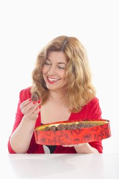 middle-aged woman in red with a box of chocolate - isolated on white