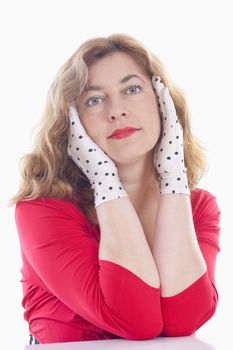 portrait of a middle-aged woman in red with polka-dot gloves - isolated on white