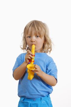 boy with long blond hair playing with toy saxophone