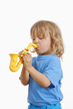 boy with long blond hair playing with toy saxophone