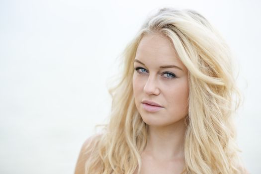 Bright portrait of a young blond woman in summer