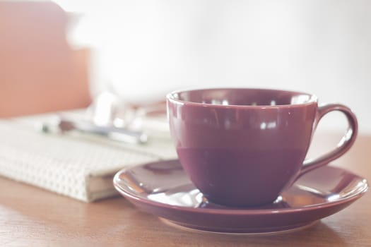 Violet coffee cup on wooden table, stock photo