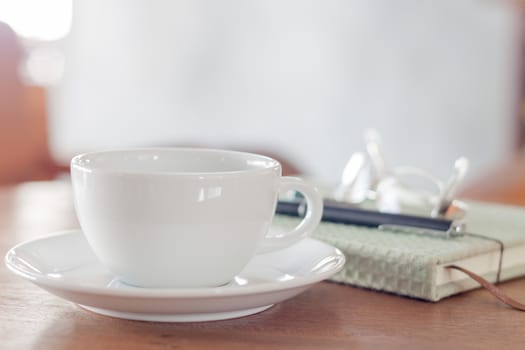 White coffee cup on wooden table, stock photo