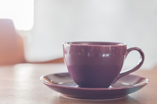 Violet coffee cup in coffee shop, stock photo