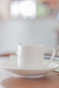 Mini white coffee cup in coffee shop, stock photo