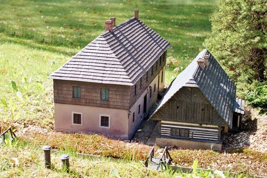 Photo shows closeup of an old house in the middle of the nature.