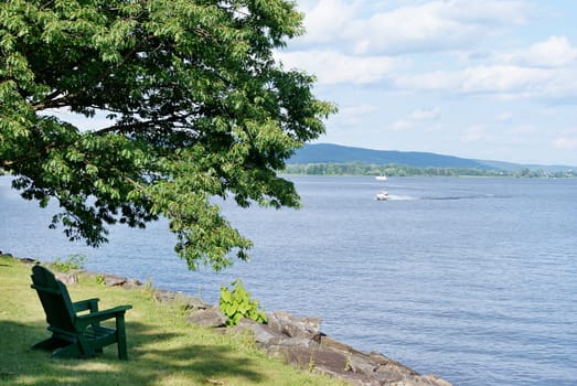 Photo shows Canadian countryside view with trees and lake.