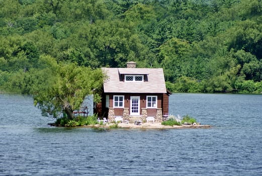 Photo shows Canadian countryside lake house and trees.