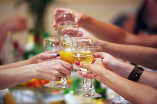 Hands holding wedding glasses with drinks