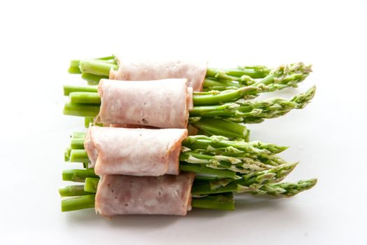 close up bacon wrapping asparagus on isolate