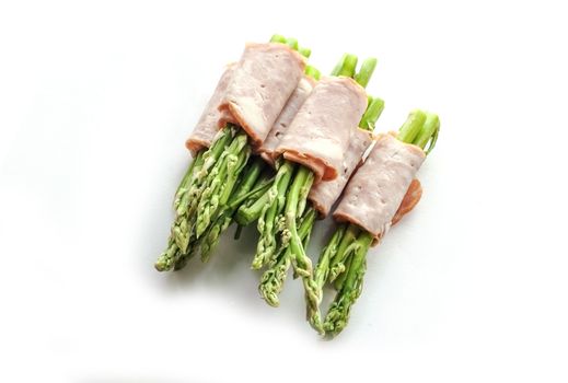 close up bacon wrapping asparagus on isolate