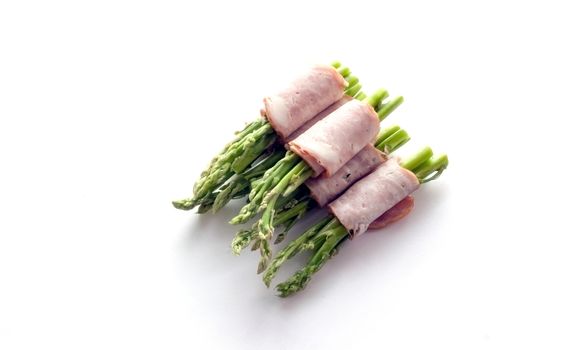 close up bacon wrapping asparagus on isolate