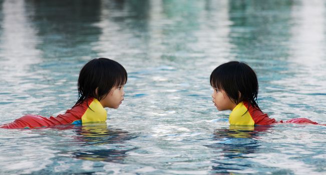 children play on water in swimimg pool in herror reflex concept