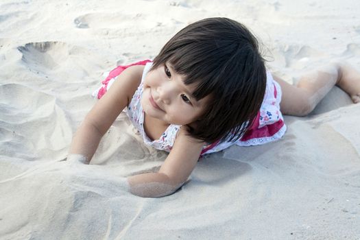 close up happy face asian girl on sand