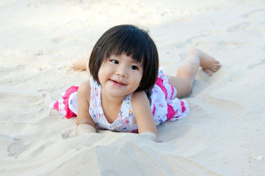 happy girl children playing on white sand 