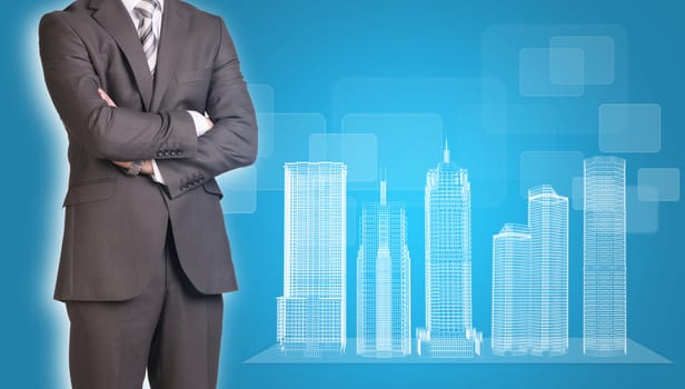 Businessman in suit stands with his arms crossed. Glowing wire-frame buildings on transparent plane as backdrop