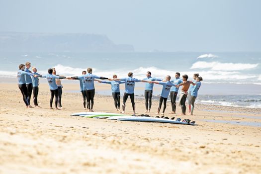 VALE FIGUEIRAS, PORTUGAL - August 16 2014:  Surfers doing excersises on the famous surfers beach Vale Figueiras in Portugal