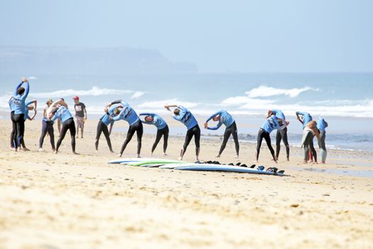 VALE FIGUEIRAS, PORTUGAL - August 16 2014:  Surfers doing excersises on the famous surfers beach Vale Figueiras in Portugal