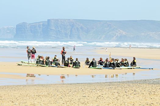 VALE FIGUEIRAS, PORTUGAL - August 16 2014:  Surfers doing excersises on the famous surfers beach Vale Figueiras in Portugal