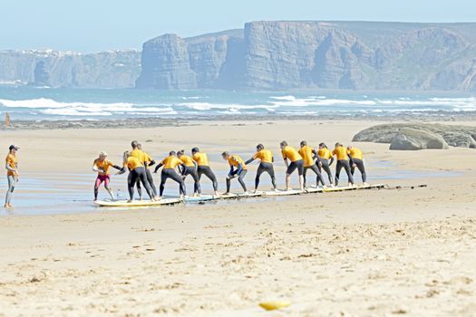 VALE FIGUEIRAS, PORTUGAL - August 29 2014:  Surfers doing excersises on the famous surfers beach Vale Figueiras in Portugal