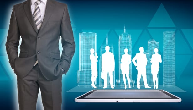 Businessman in suit standing and holds hands in pockets. Glowing wire-frame buildings and business silhouettes on screen tablet pc as backdrop