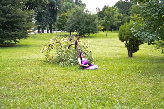 The pregnant girl on walk in city park