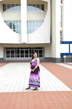 The pregnant girl on walk in city park