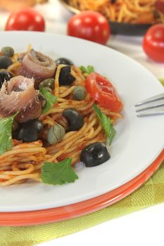 Spaghetti alla puttanesca with olives, capers and anchovies