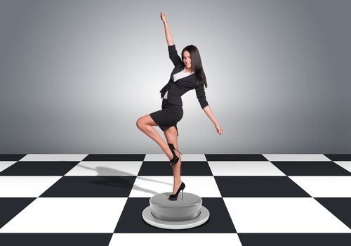 Beautiful businesswoman posing and looking into camera. Floor with checkerboard texture and gray wall