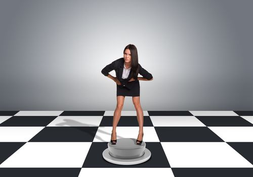 Beautiful businesswoman holding his belly leaning forward. Floor with checkerboard texture and gray wall