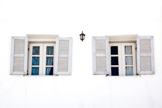 opne vintage windows on white cement wall